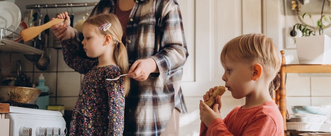 Family cooking together at a stove