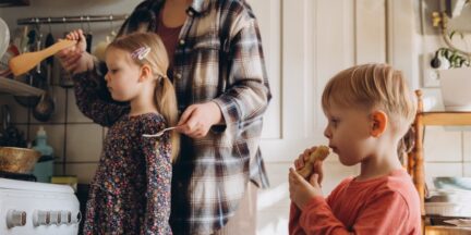 Family cooking together at a stove